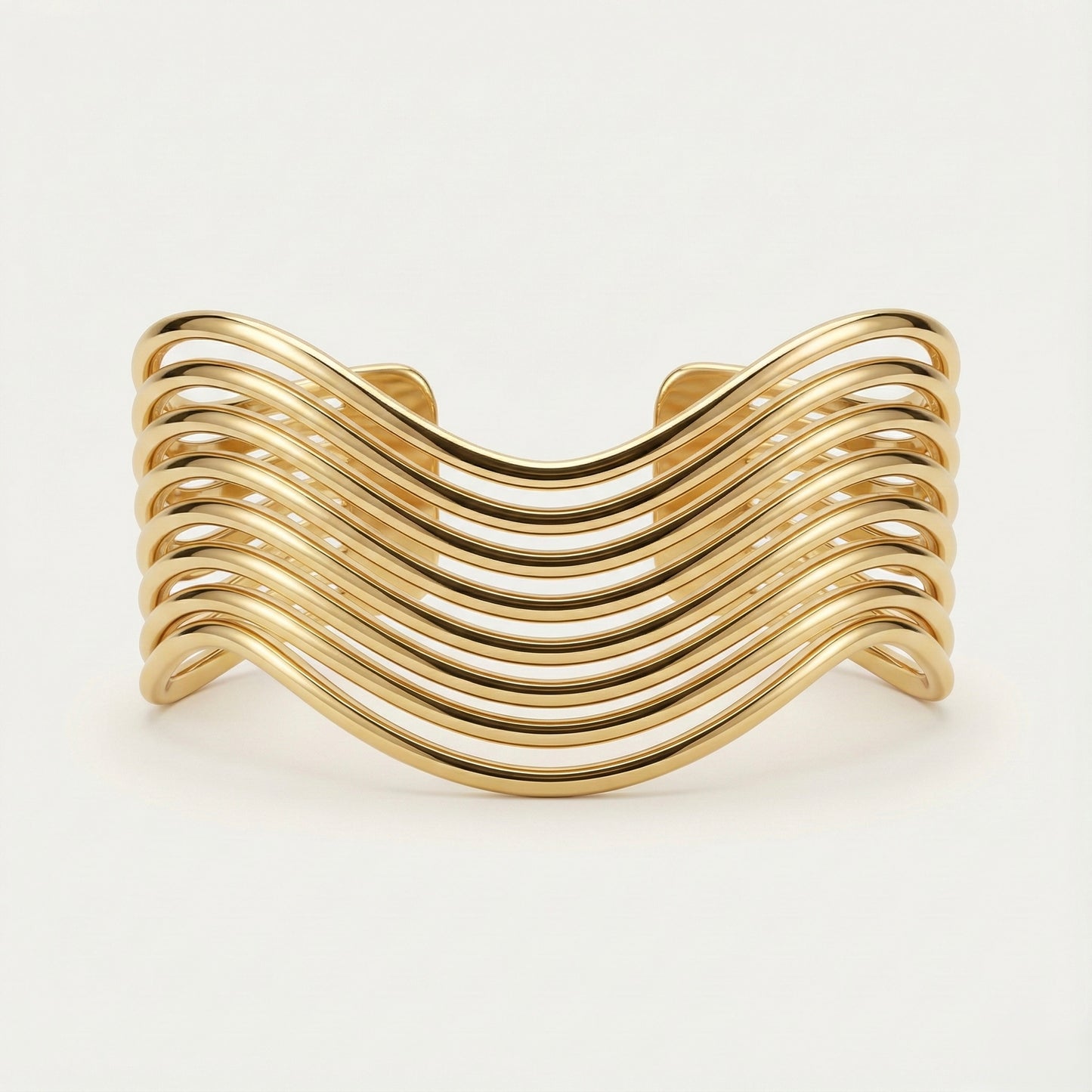 Gold bracelet with wavy design on a white background