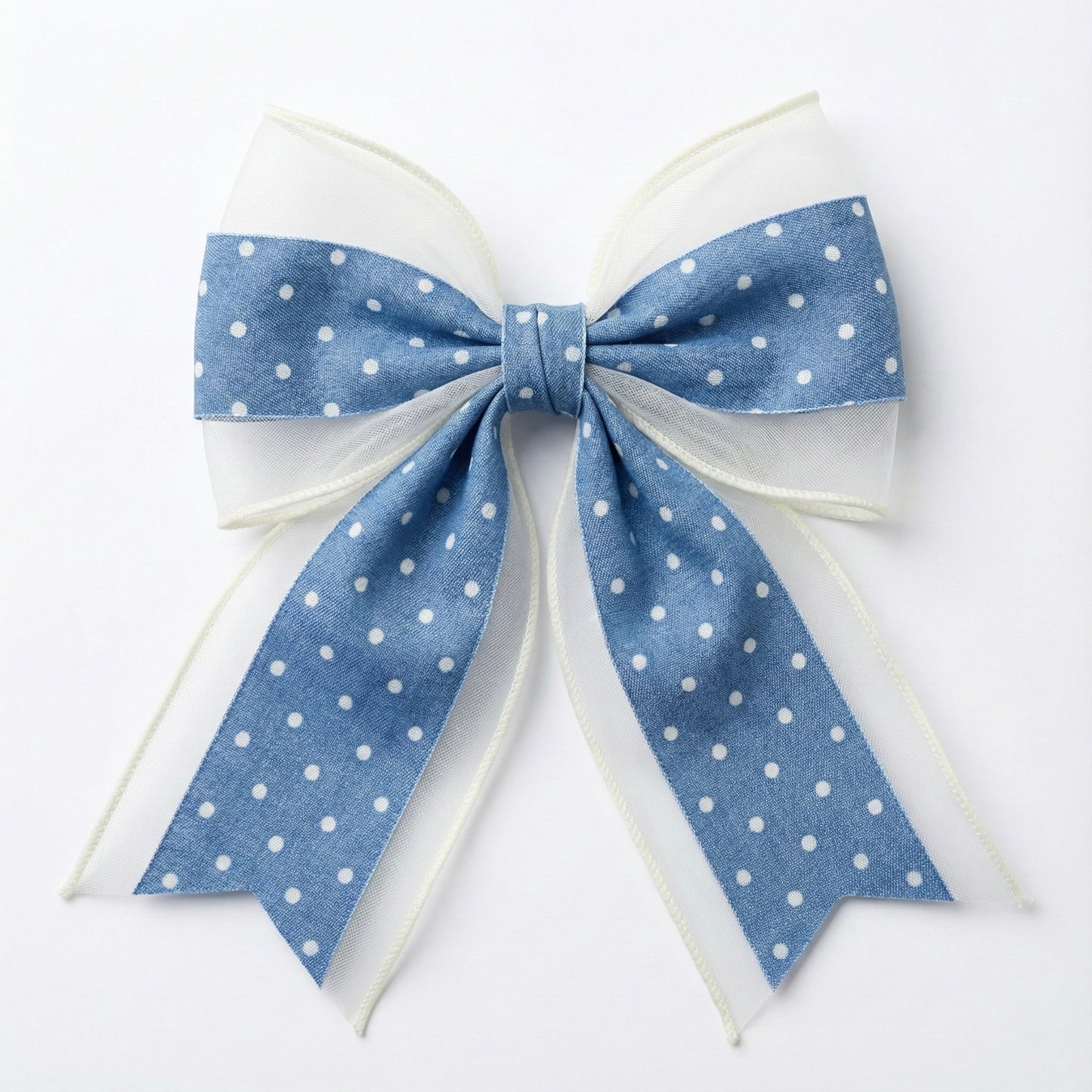 Large blue polka dot bow on a white background