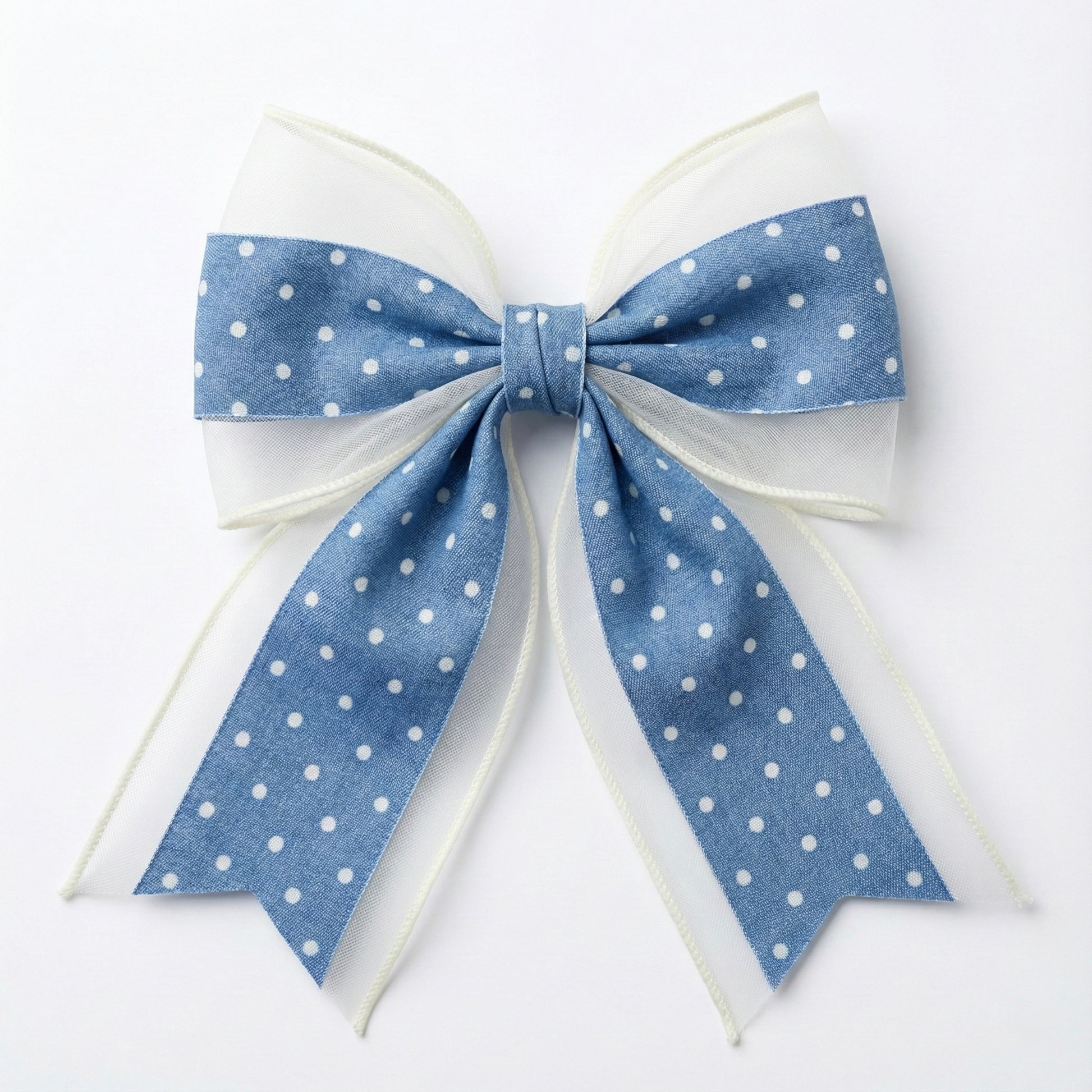 Large blue polka dot bow on a white background