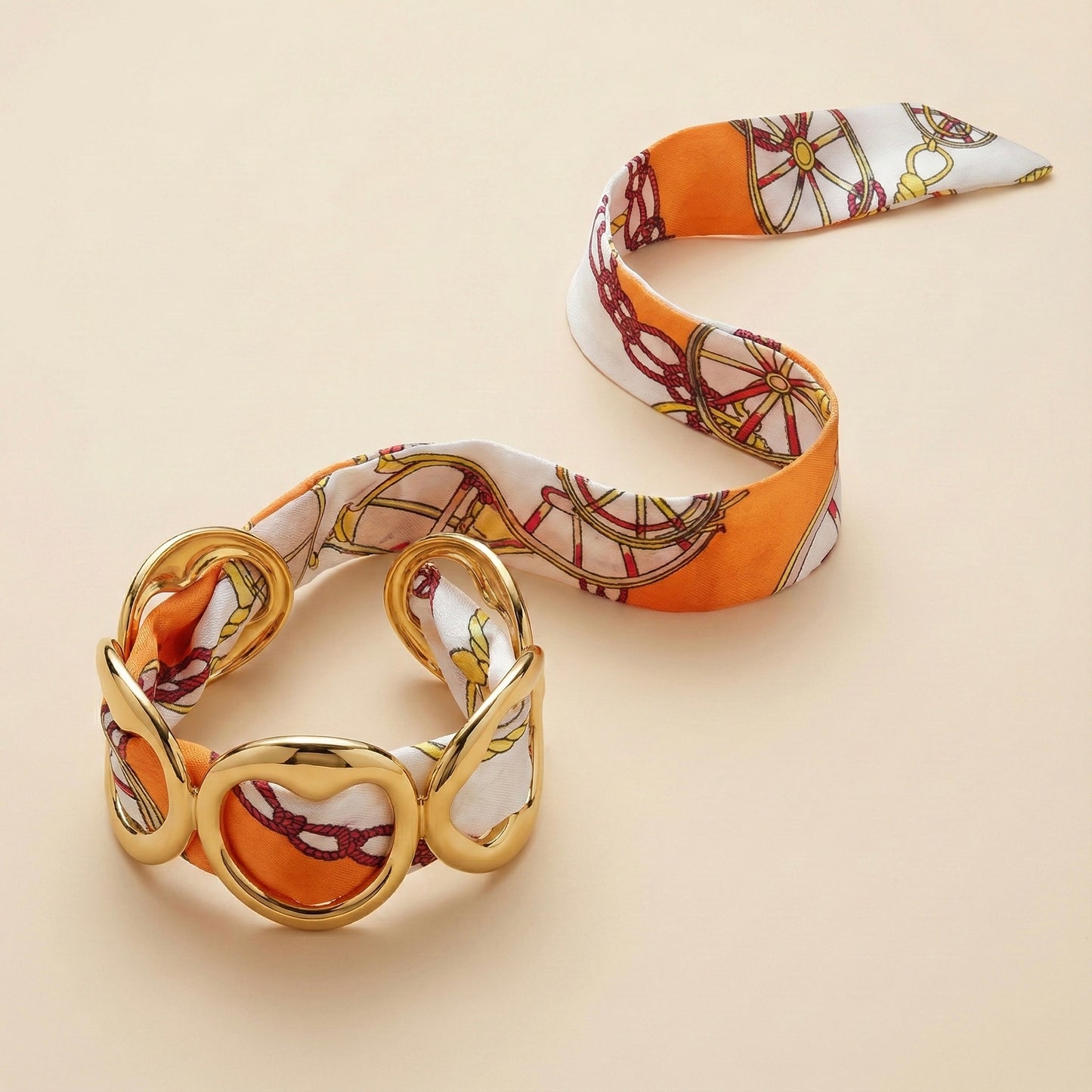 Gold bracelet with a patterned band on a beige background