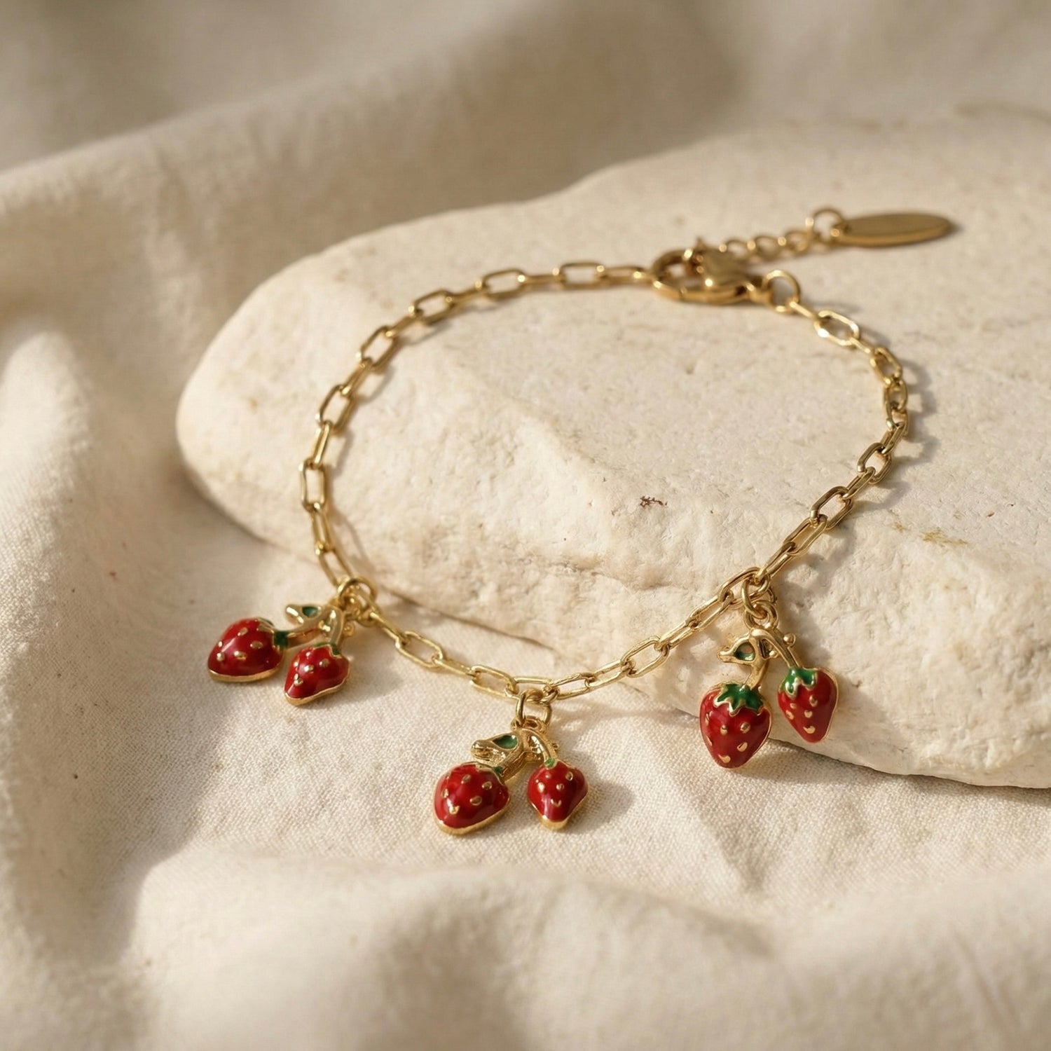 “Gold plated strawberry charm bracelet with enamel detailing – Myst Juels”