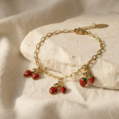 “Gold plated strawberry charm bracelet with enamel detailing – Myst Juels”