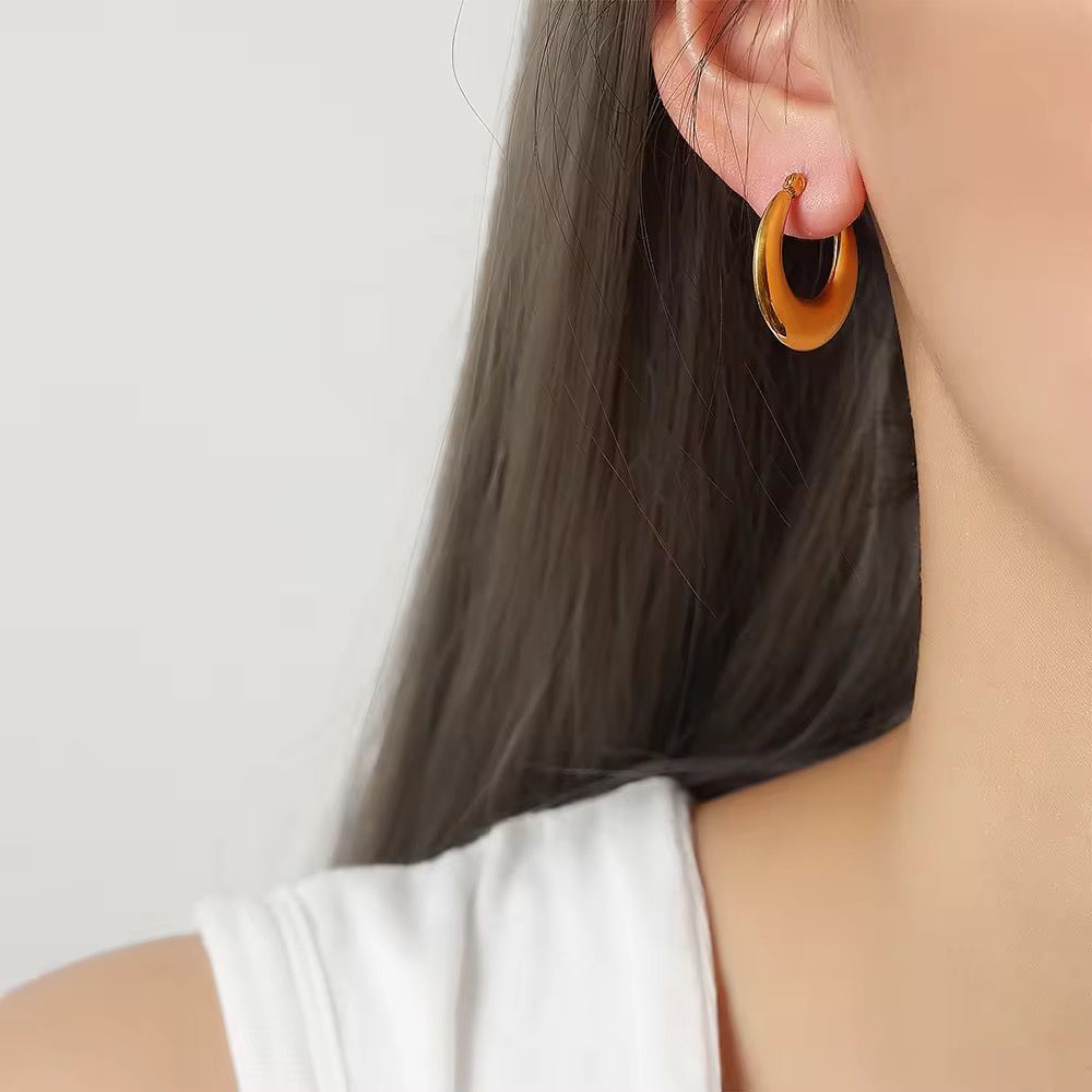 Person wearing a tortoiseshell hoop earring 