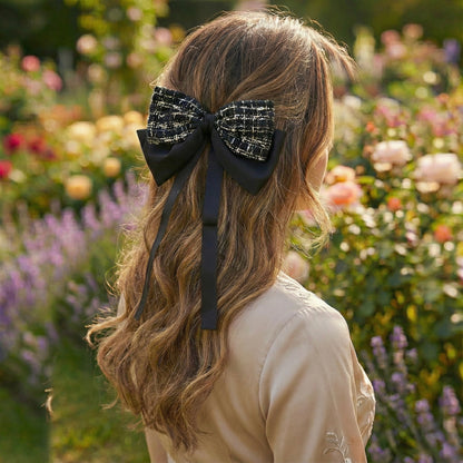 Luxury black hair bow worn in half up hairstyle