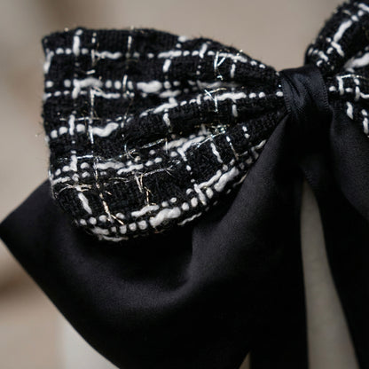Close up of tweed and satin fabric luxury hair bow