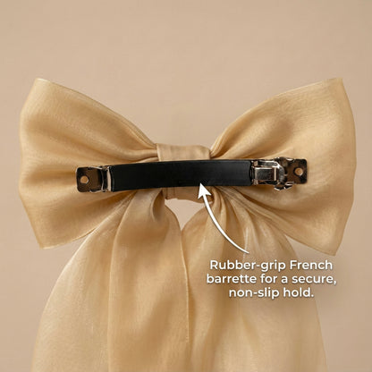 Beige bow hair clip with rubber-grip French barrette on a beige background