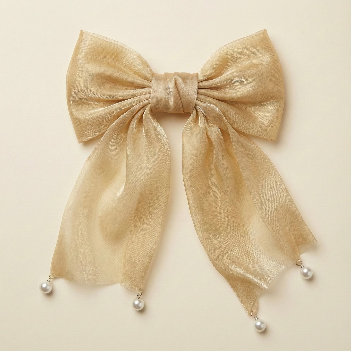 Beige bow with pearl decorations on a beige background
