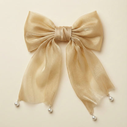 Beige bow with pearl decorations on a beige background