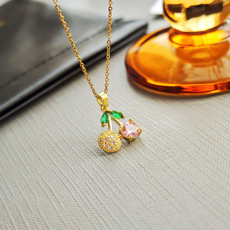 Gold necklace with a cherry pendant \