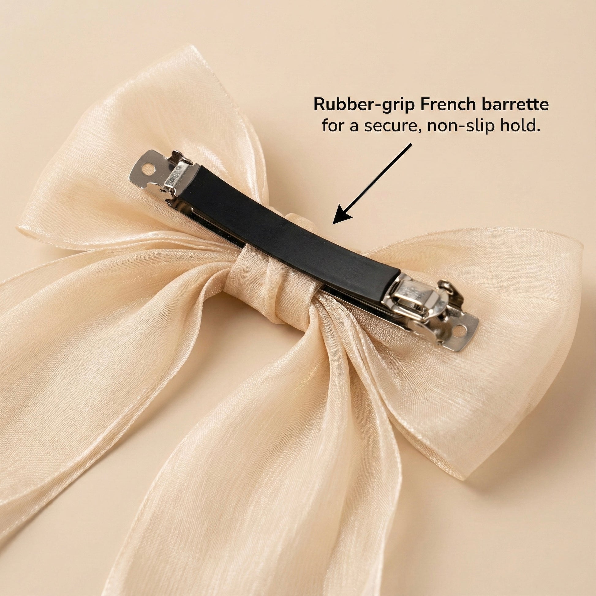 Beige bow hair clip with rubber-grip French barrette on a beige background