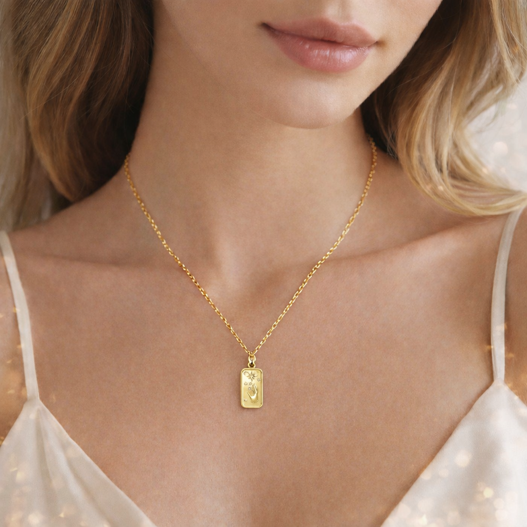 Gold necklace with a pendant worn by a person 